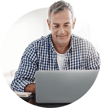 A man smiling at his computer