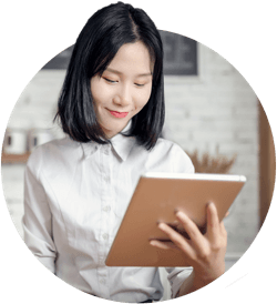 A woman smiling at her tablet
