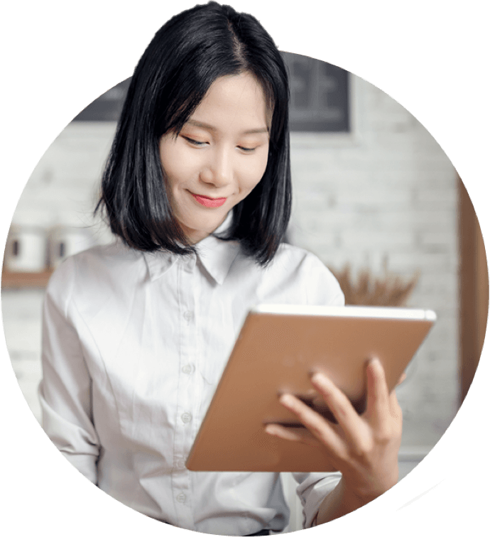 A woman smilng at her tablet