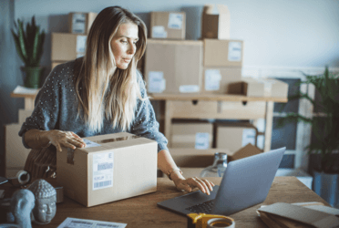 woman using laptop packing