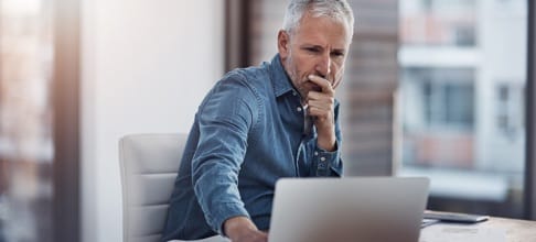 man on laptop blue shirt
