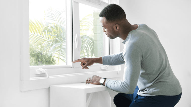 man locking window with smart home products