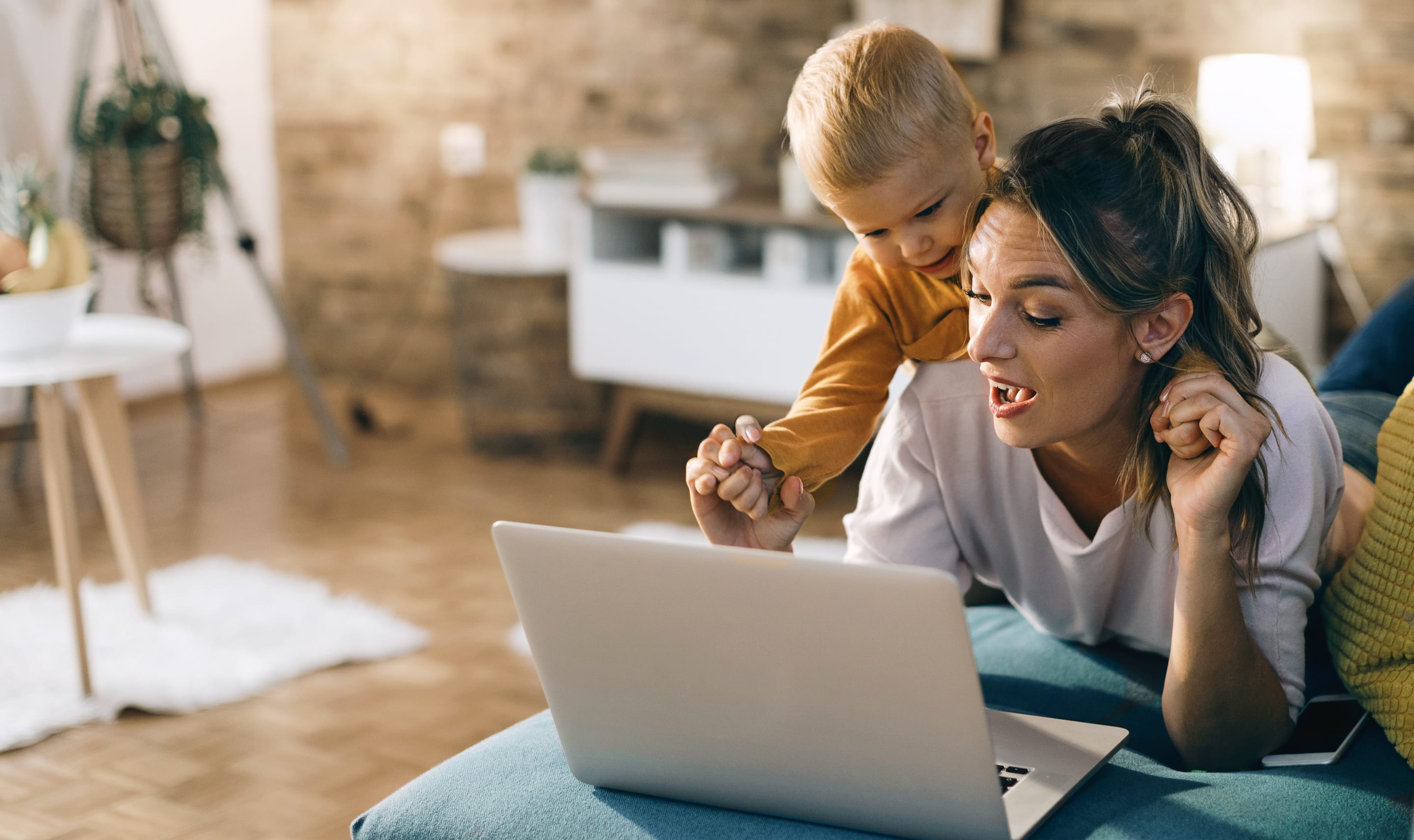 A mother and child using a laptop