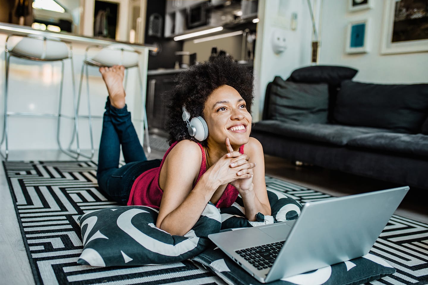 A woman listening to music while working on a laptop