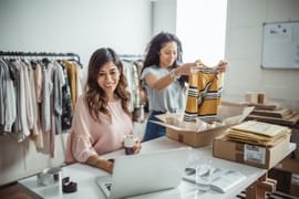 Two working in a small clothing store business.