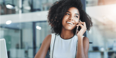 A girl smiling while talking on the phone
