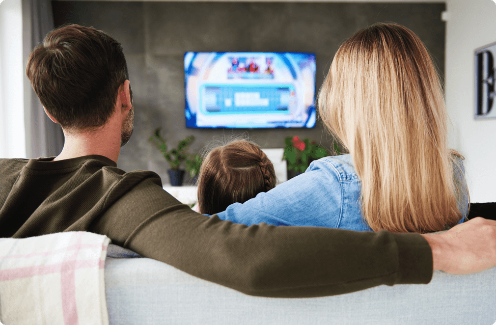A family on a couch watching tv