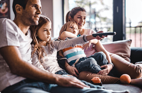 a family watching TV from their couch