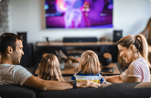 A family on the couch watching TV