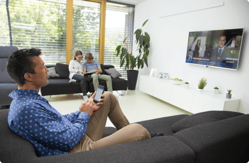 A family on the couch using different devices