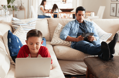 A father and son using different devices
