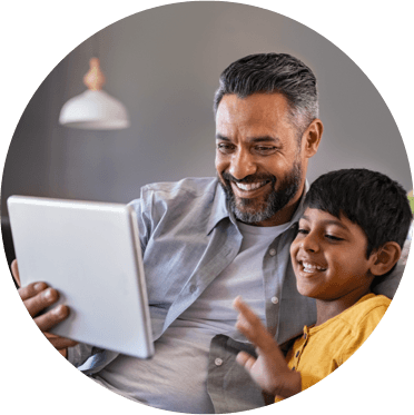 father and son looking at tablet