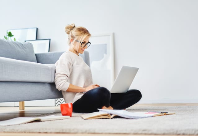 woman sitting on floor with laptop