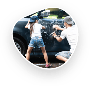 A father and daughter handwashing a car