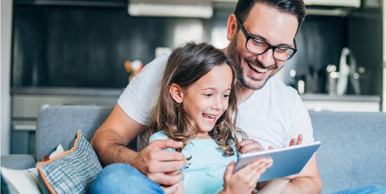 father and daughter looking at tablet