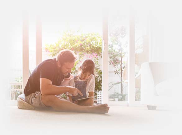 Father and daughter looking at device