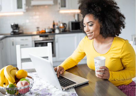 a woman using a computer on a coffee table