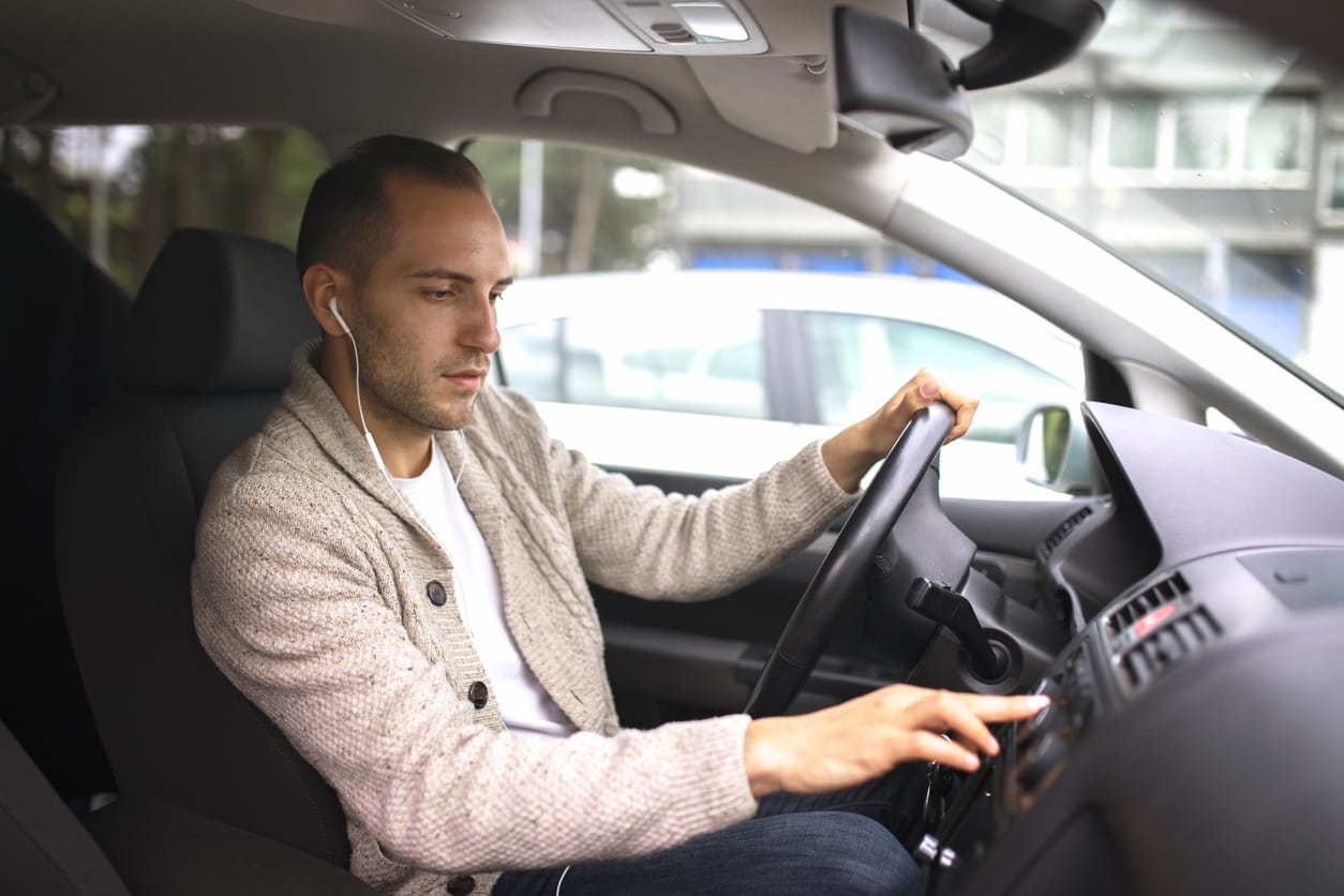 person driving with headphones on