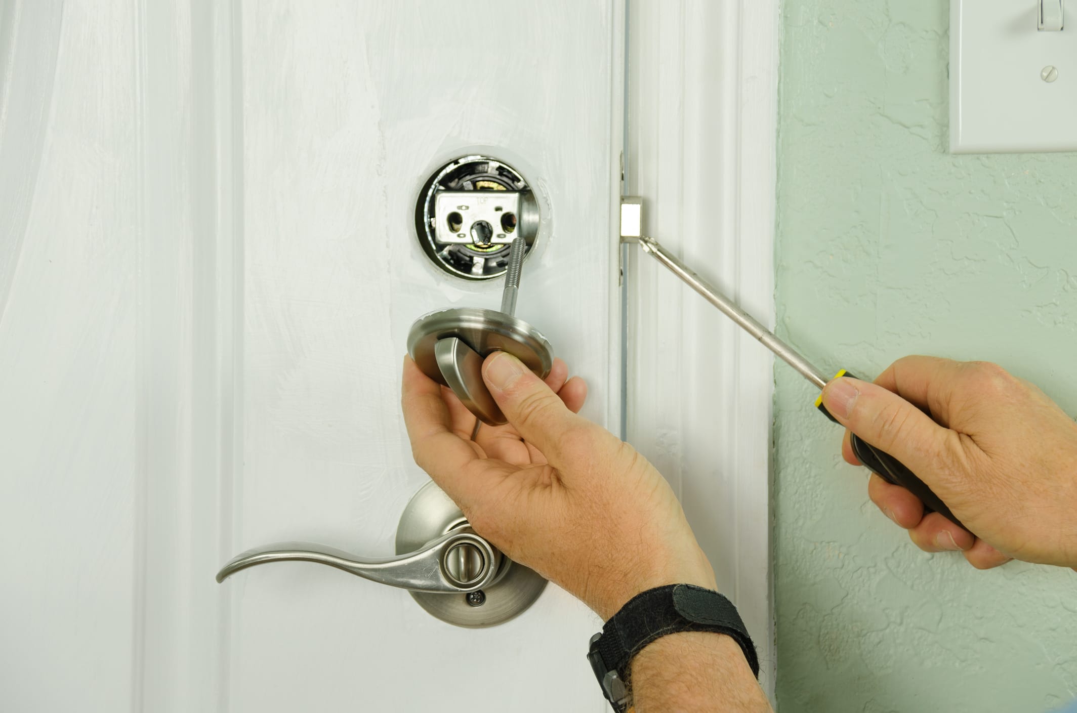 person installing door lock