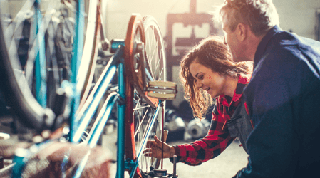 people looking at a bike