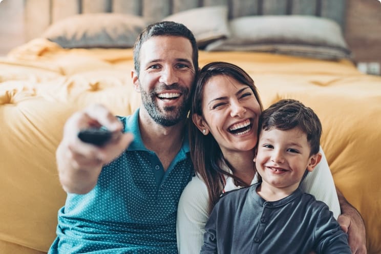 family changing channel and laughing