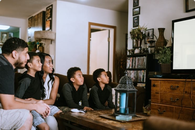 family in living room watching TV