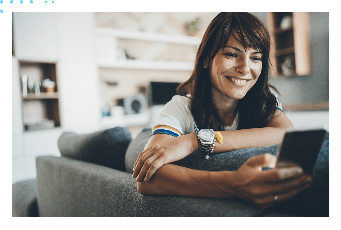 woman on couch looking at phone