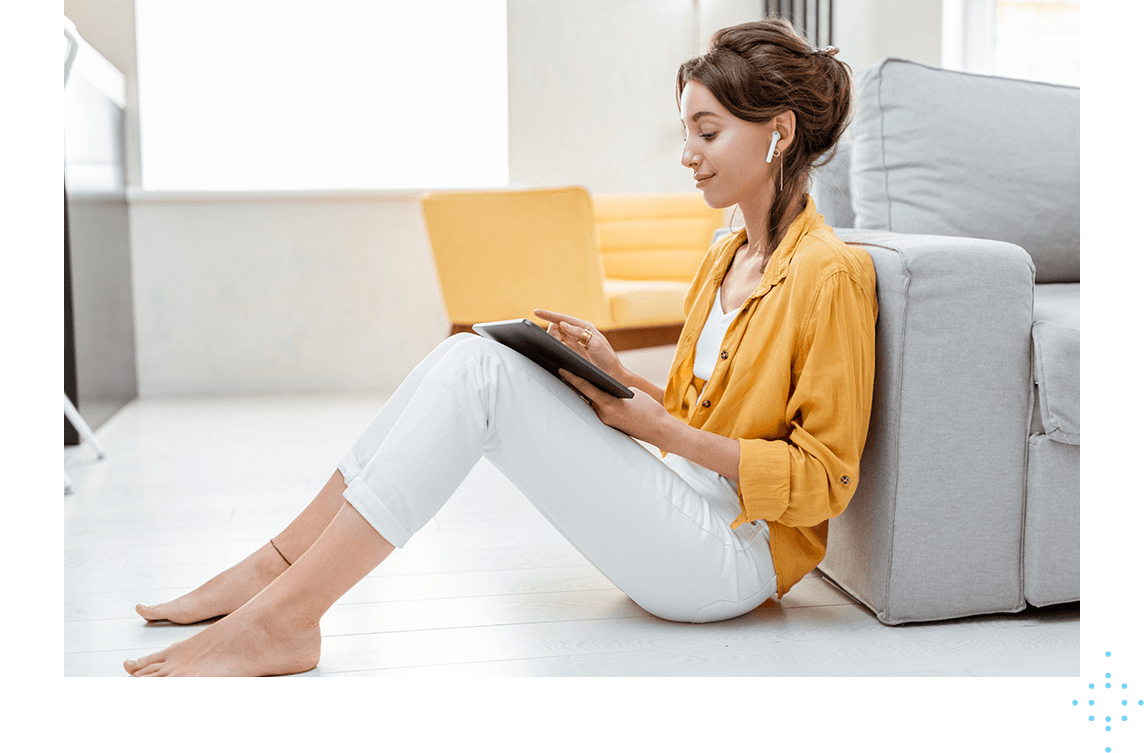 woman sitting on floor using tablet