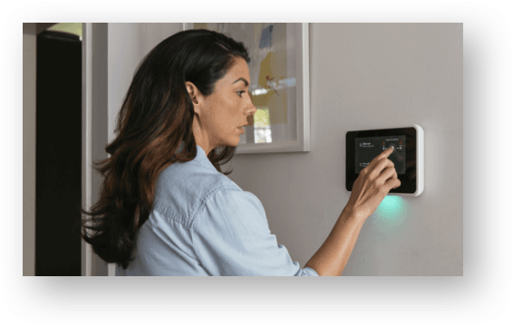 woman using vivint hub on the wall