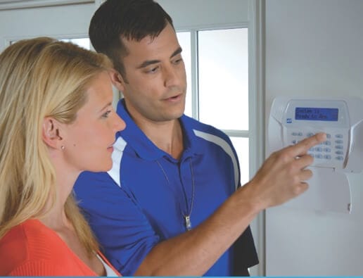 ADT home security technician installing keypad