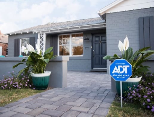 Home with an ADT sign in the front yard