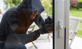 Image of burglar attempting to break into home