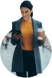 Woman with coffee in one hand and cell phone in the other
