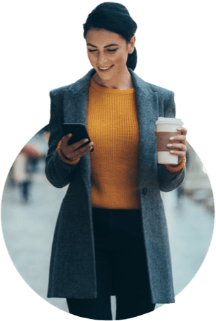 Woman with coffee in one hand and cell phone in the other