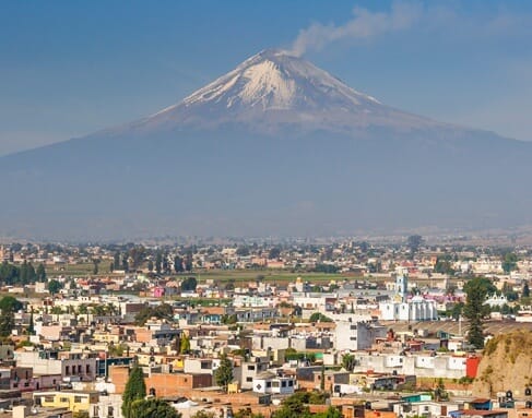 An active volcano towering over a city